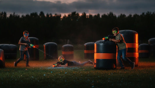 Kids playing gel blaster party games behind inflatable bunkers