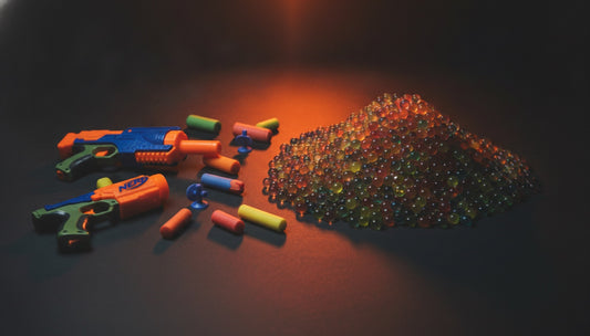 Foam darts and gel blaster water beads side by side